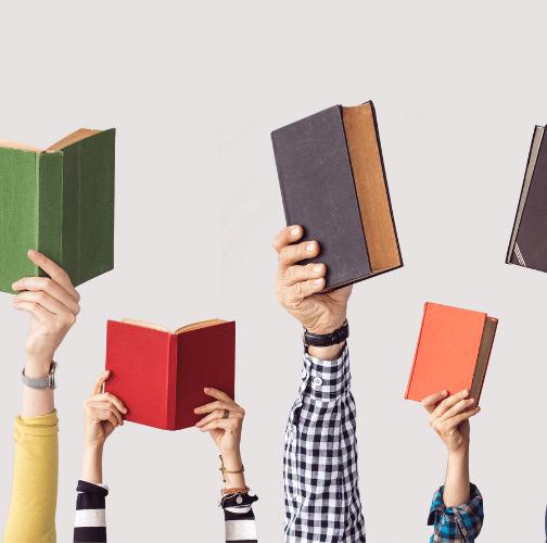 A groups of arms displaying books lifted in the air-Book Lovers Gifts - Gizmo Gifts