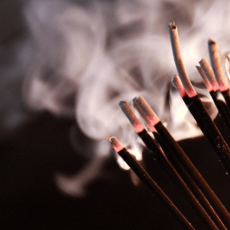 A series of smoking incense sticks with a black background- Gizmo Gifts