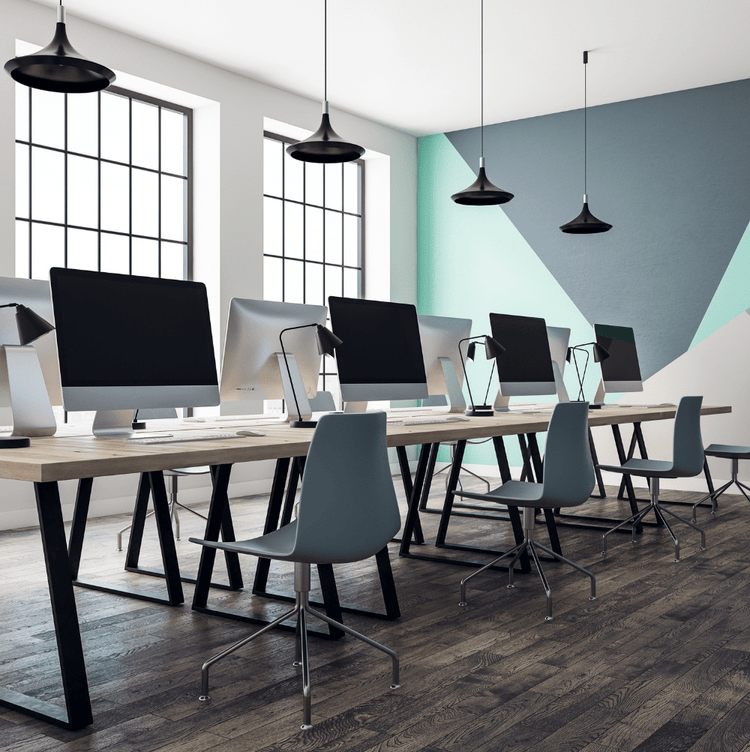 An urban office space featuring four desks in a row with Apple desktop computers-Office Gizmos - Gizmo Gifts