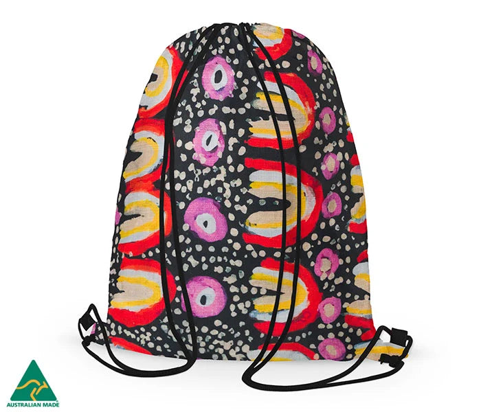 Drawstring bag featuring Aboriginal art by Maggie Long on a white background and a green Australian made emblem in the right hand corner.