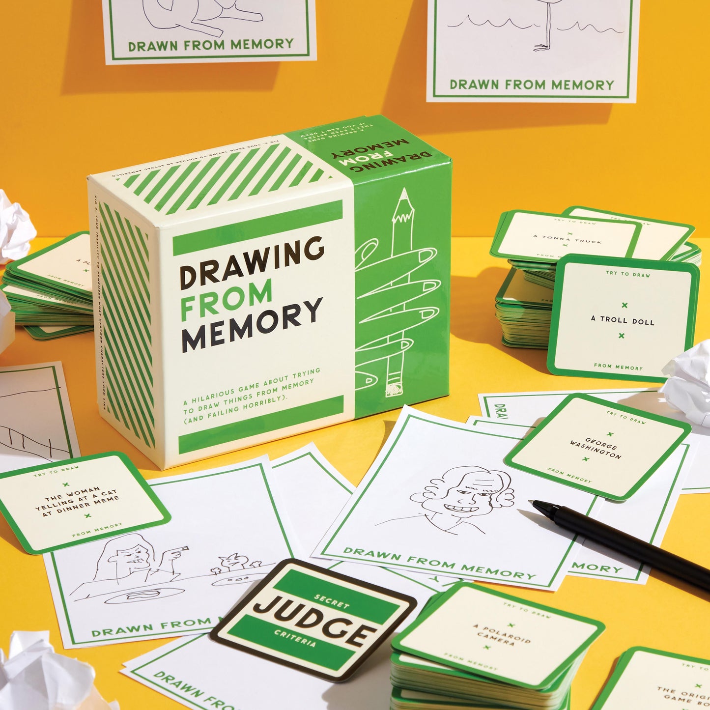Drawing From Memory game with cards and box on a yellow surface