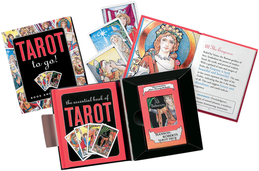 Collection of tarot cards and books on a white background