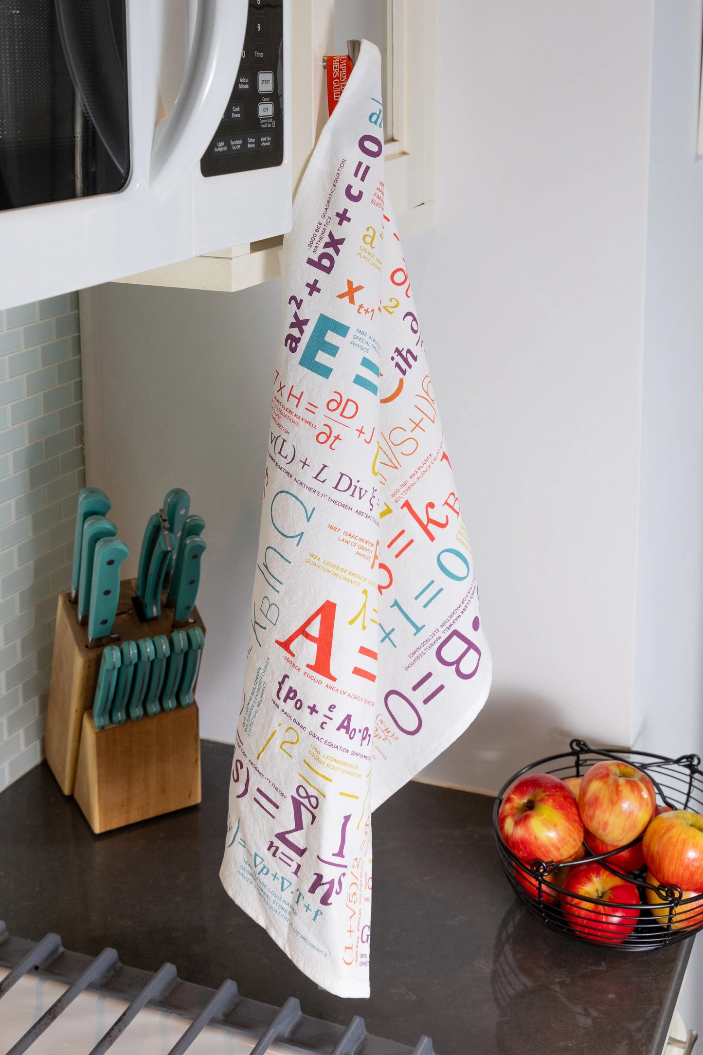 Kitchen towel with mathematical equations hanging on a kitchen rack