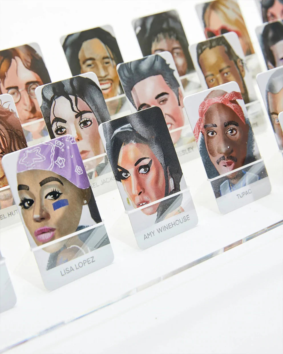 Collection of cards with various celebrities' faces on a white background