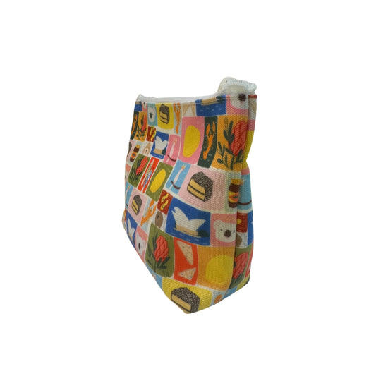 Colorful patterned travel pouch side view on a white background