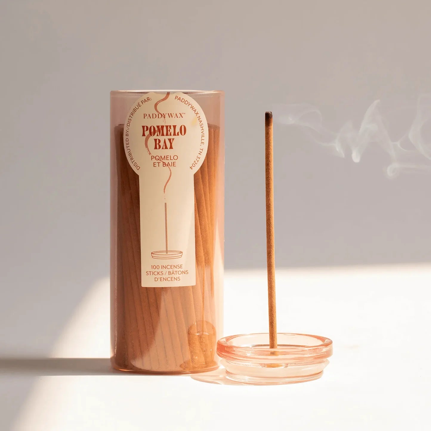 Incense stick with packaging labeled 'Pomelo Bay' on a light background