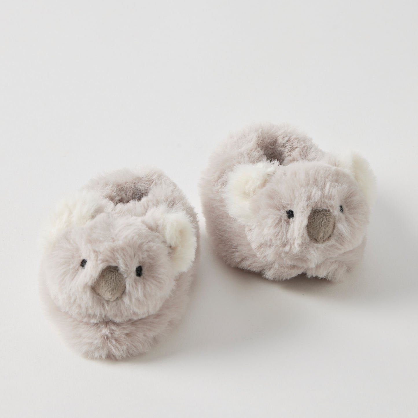 Koala shaped baby booties on a white background