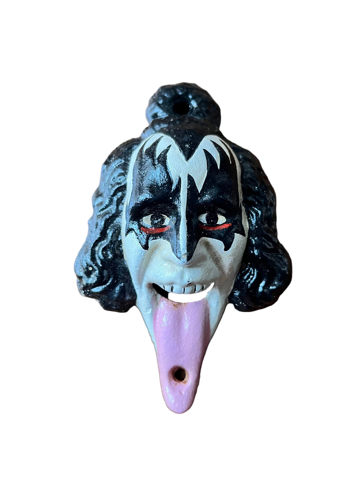 A Gene Simmons Kiss character shaped bottle opener, with a pink tongue and hole opening on a white background.
