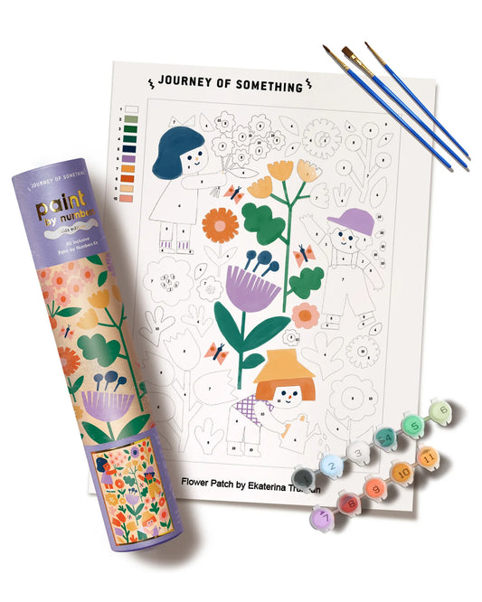 Coloring book with paint by numbers kit, markers, and color swatches on a white background