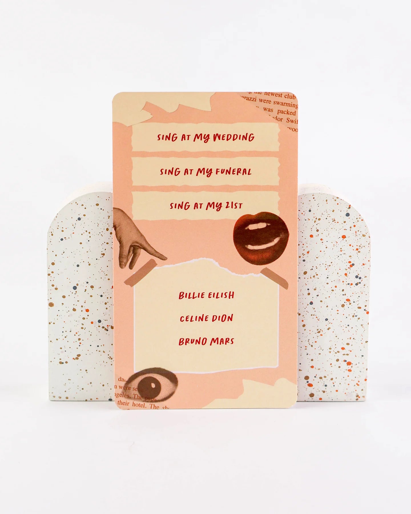 Card with text 'Sing at my wedding, sing at my funeral, sing at my list' featuring famous names on a speckled background.