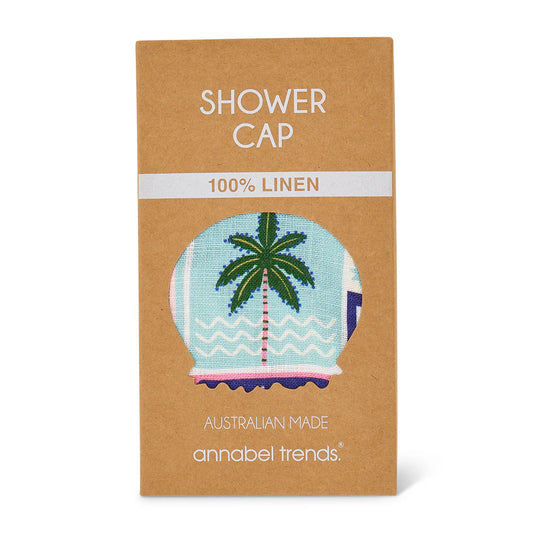 Packaging of a shower cap with a palm tree design, labeled '100% linen' and 'Australian made' by annabel trends.