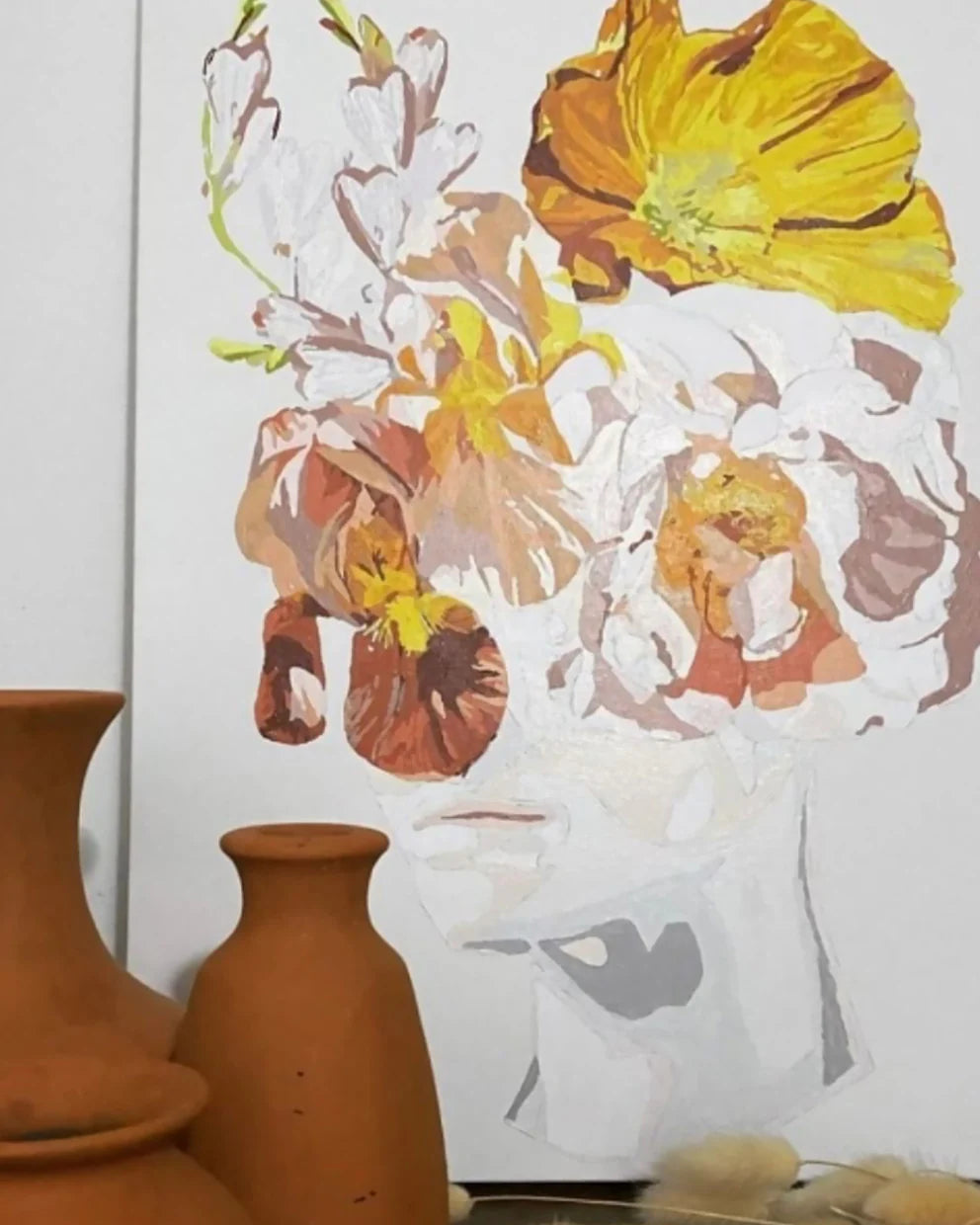 Floral artwork with yellow and brown flowers on a white background, with terracotta vases in the foreground.