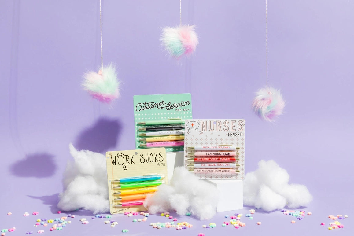 Colorful pens sets with decorative packaging on a purple background