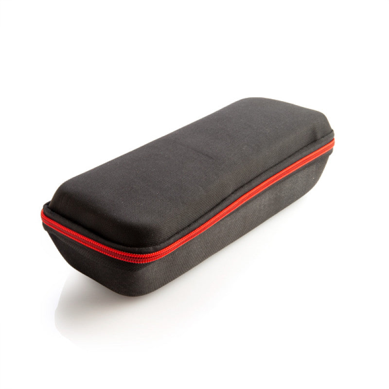 Black rectangular case with a red zipper on a white background