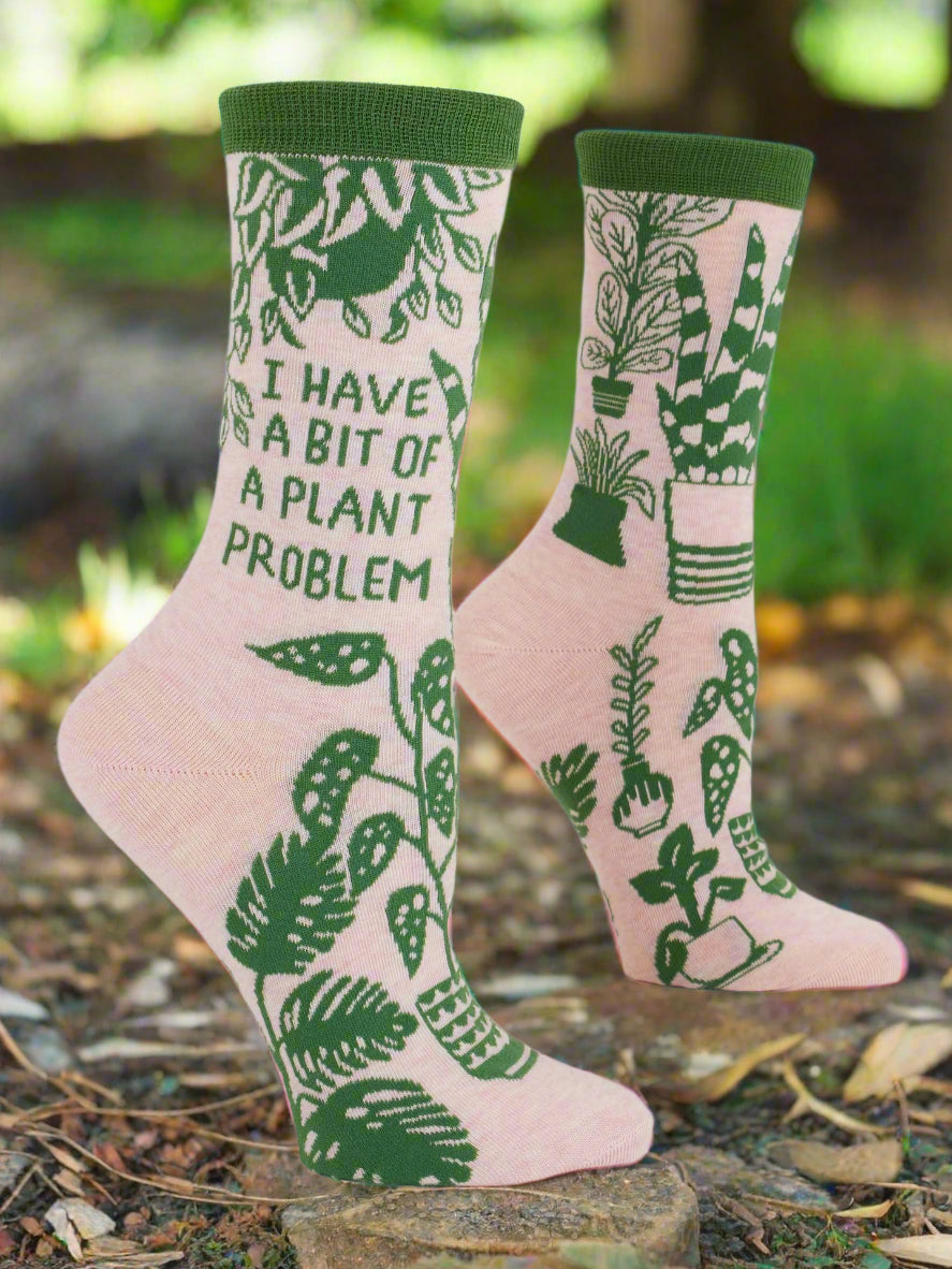 Pair of socks with plant-themed design and text on a white background