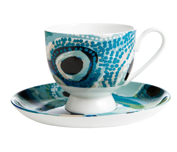 Tea cup and saucer set by May Wokka Chapman on a white background.