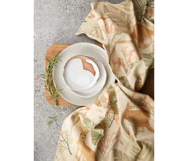 Cotton kangaroo tea towel placed beside a table setting and a concrete background