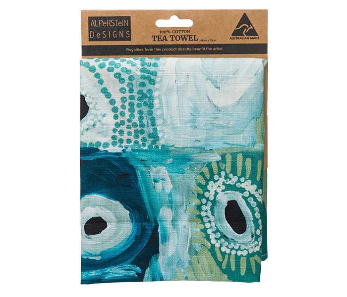 A folded Tea towel on a carded header featuring - Australian indigenous art by May Wokka Chapman