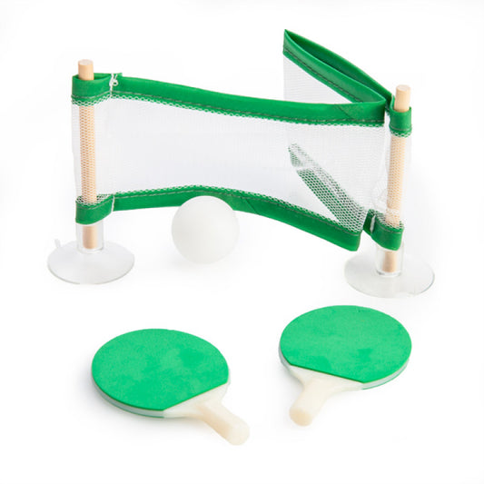 Miniature table tennis set with green paddles and net on a white background