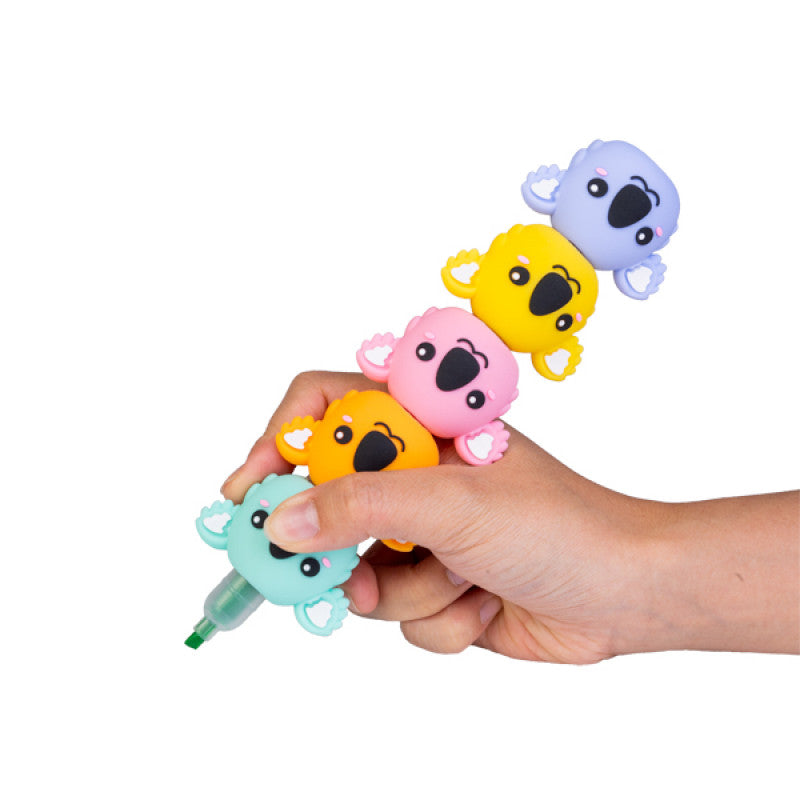 A hand holding a tower of Koala Highlighters on a white background.