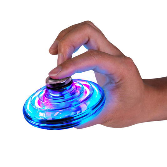 Hand holding a glowing blue and pink fidget spinner on a white background