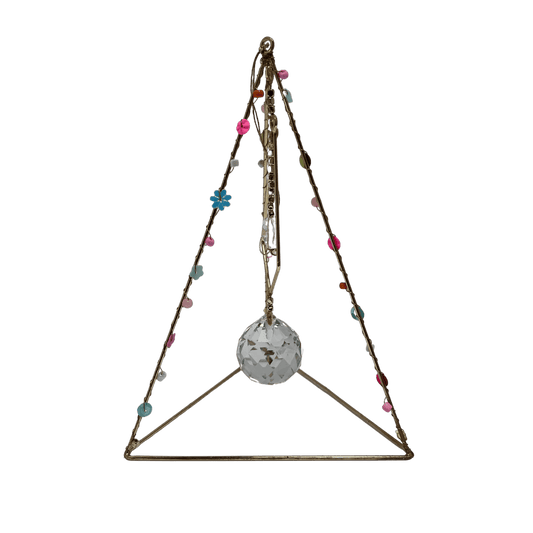 Wire  pyramid shaped and free-standing suncatcher. A large crystal hangs in the middle. Hand made in India.