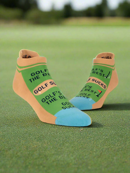 A pair of BLUE Q Sneaker socks - Golf sucks L/XL on a golf tee background- Gizmo Gifts