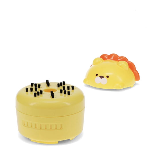 Yellow lion-shaped desk vacuum on a white background