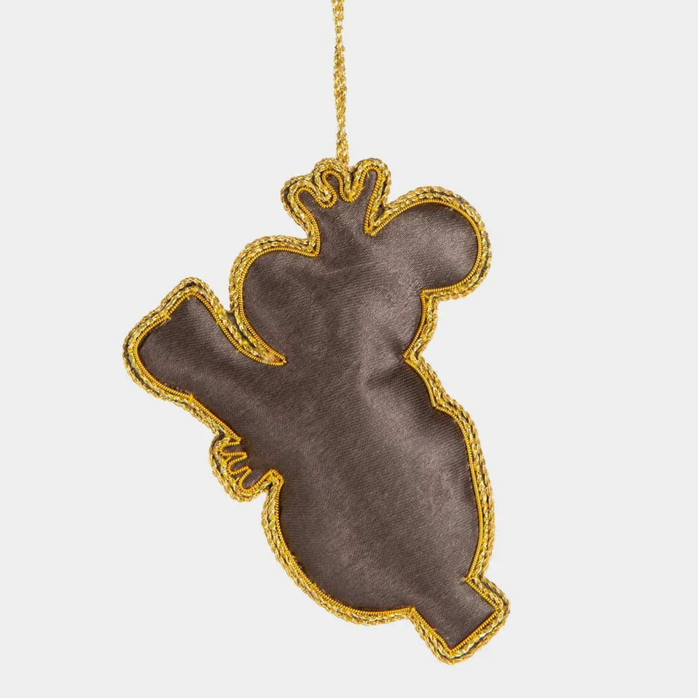 Back view of Decorative ornament shaped like a stylized koala with gold embroidery on a white background