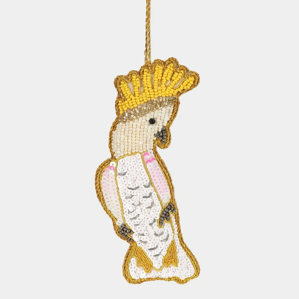 Decorative ornament shaped like a bird with a yellow beak and crown on a white background