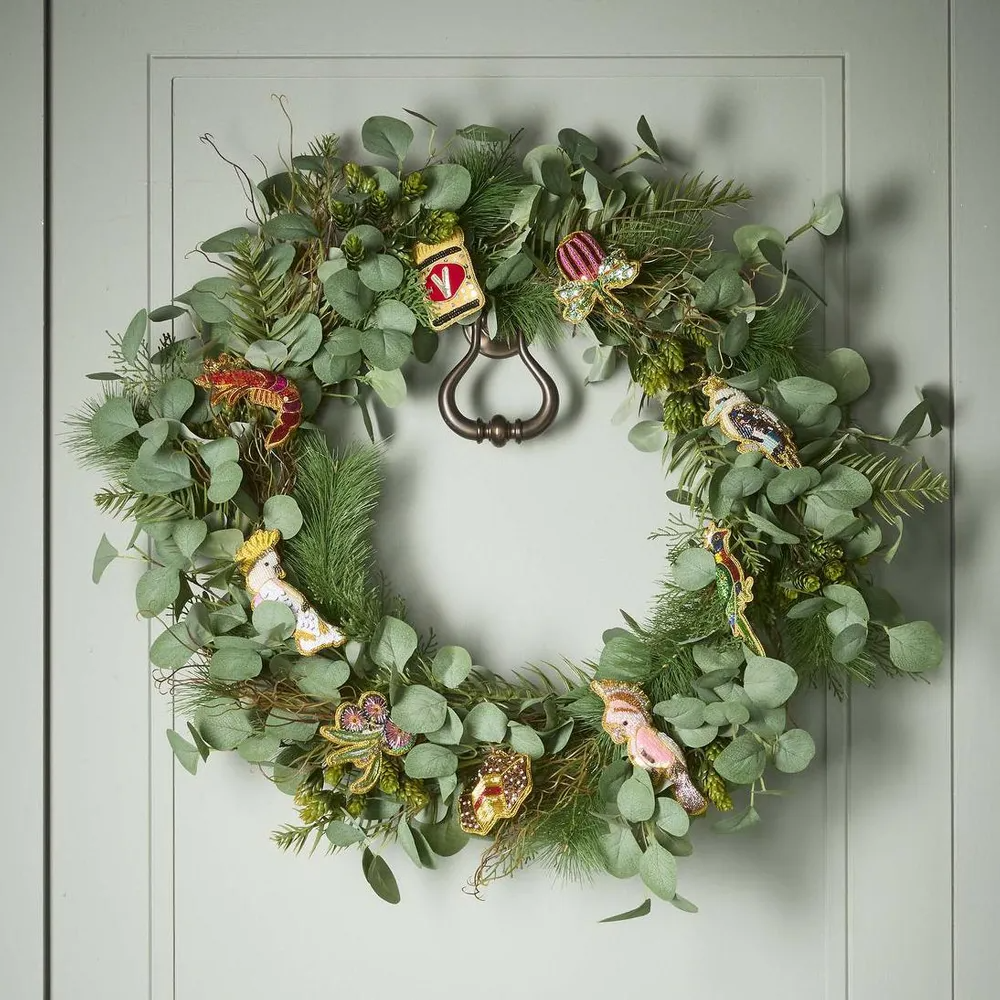Decorative green wreath with ornaments on a light gray background