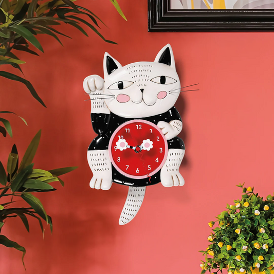 Cat-shaped wall clock with a red face on a pink wall.