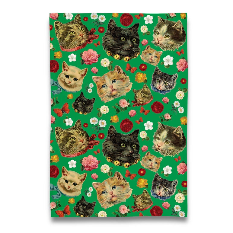 Tea towel with cat and flower pattern on a green background