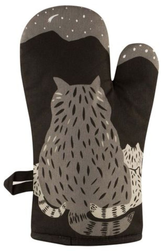 Back view of black oven mitt with backside of cartoon racoon. Design by BLUE Q