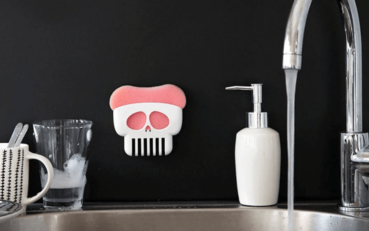 PELEG Brain Drain skull sponge holder attached to a black wall- Gizmo Gifts