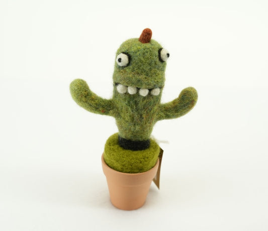 A crazy looking green wool felt decoration in the form of a potted cactus placed on a white background.