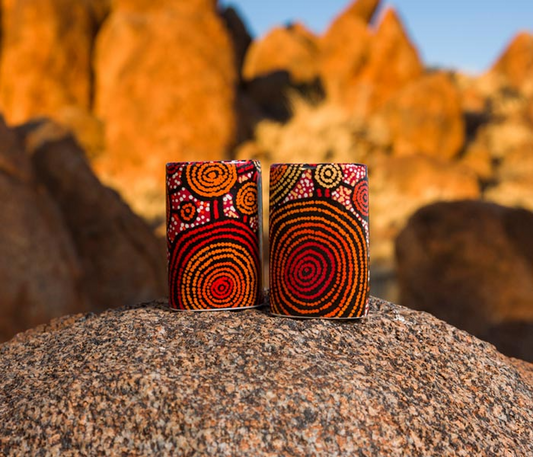 Salt and pepper shakers , background is a desert landscape.