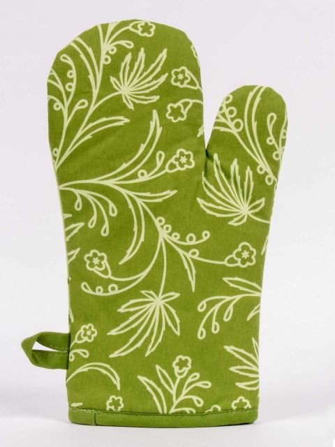 Back view of green BLUE Q Oven glove with an overall pattern of leaves on a white background.