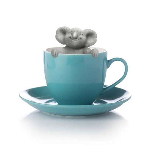 FRED Koala Tea Dweller tea infuser peeking out of a blue teacup and saucer on a white background- Gizmo Gifts