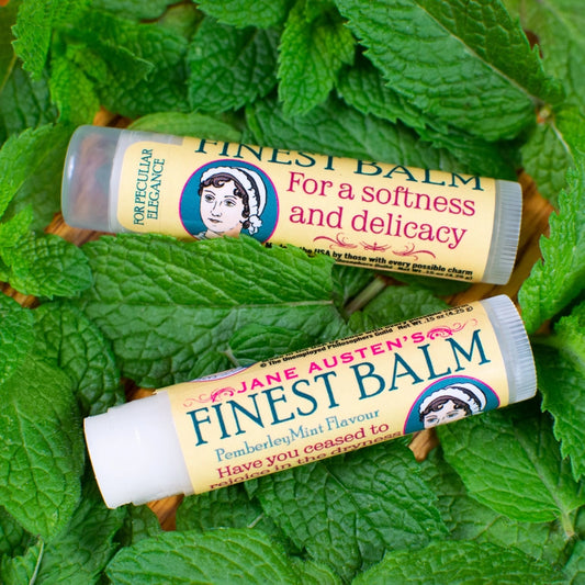 Two lip balms labeled 'Jane Austen's Finest Balm' on green leaves