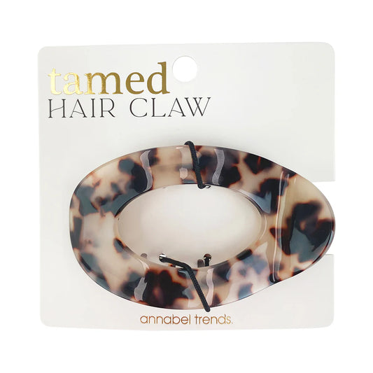Tortoiseshell hair claw on a branded card with 'tamed' and 'annabel trends' text.