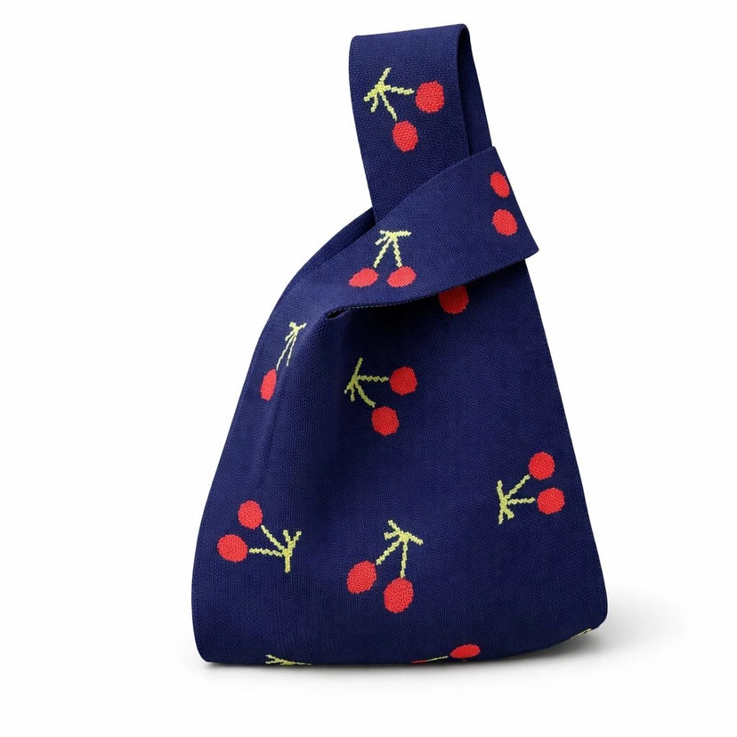 Navy blue bag with cherry pattern on a white background