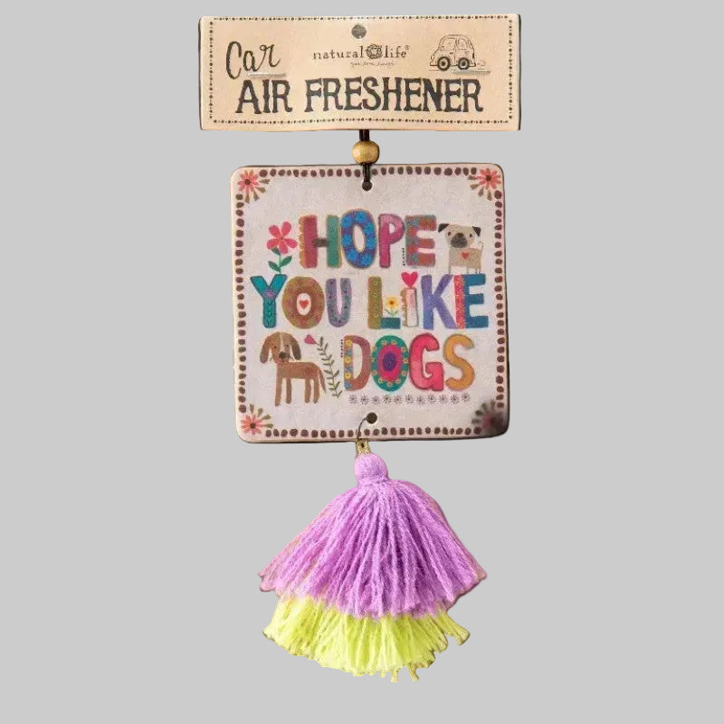 Car air freshener with colorful tassels on a cardboard backing, featuring text and dog illustrations.