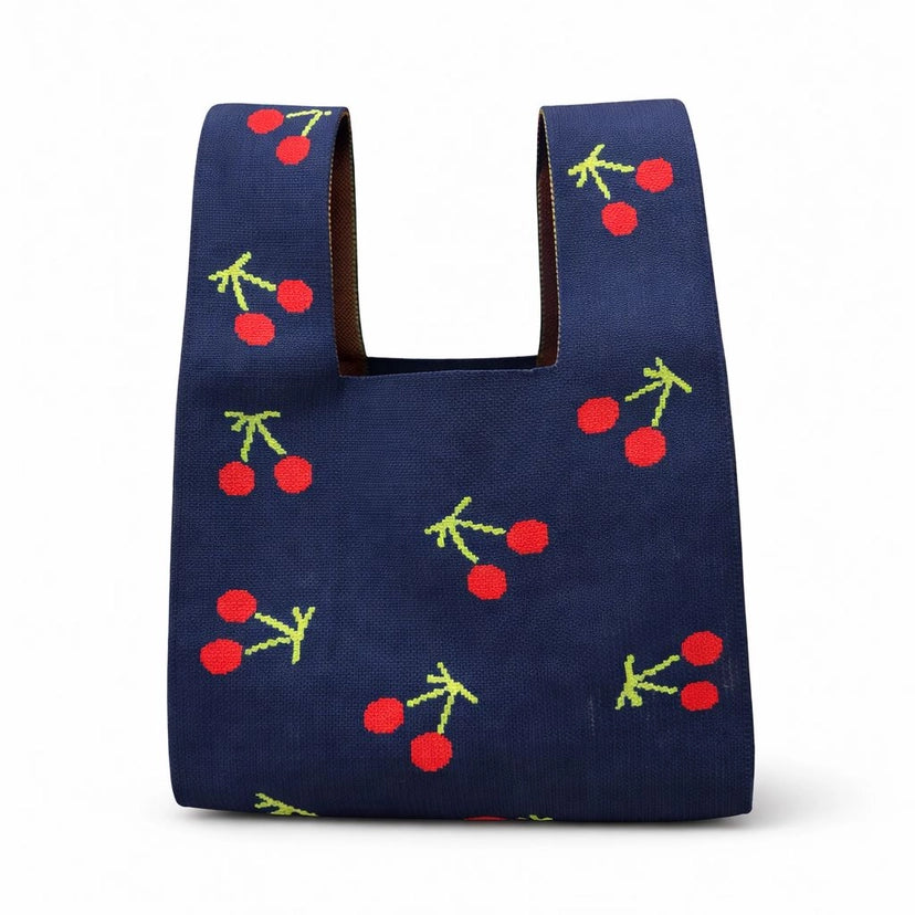 Navy blue bag with cherry pattern on a white background