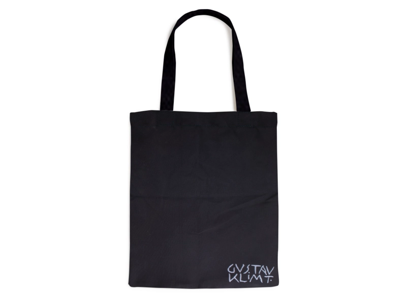 Black tote bag with white text on a white background