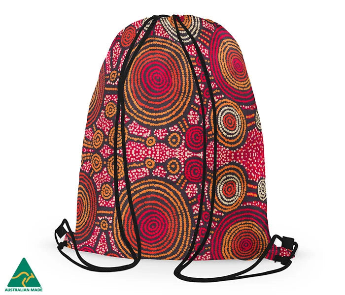 Drawstring bag featuring Aboriginal art of teddy Gibson on a white background.