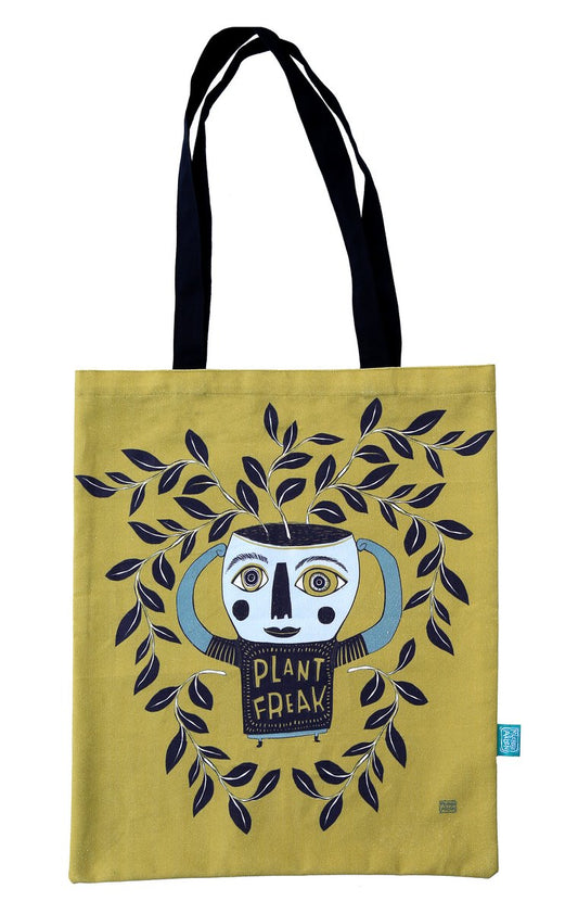 Tote bag with artistic design of a face and 'Plant Freak' text on a yellow background
