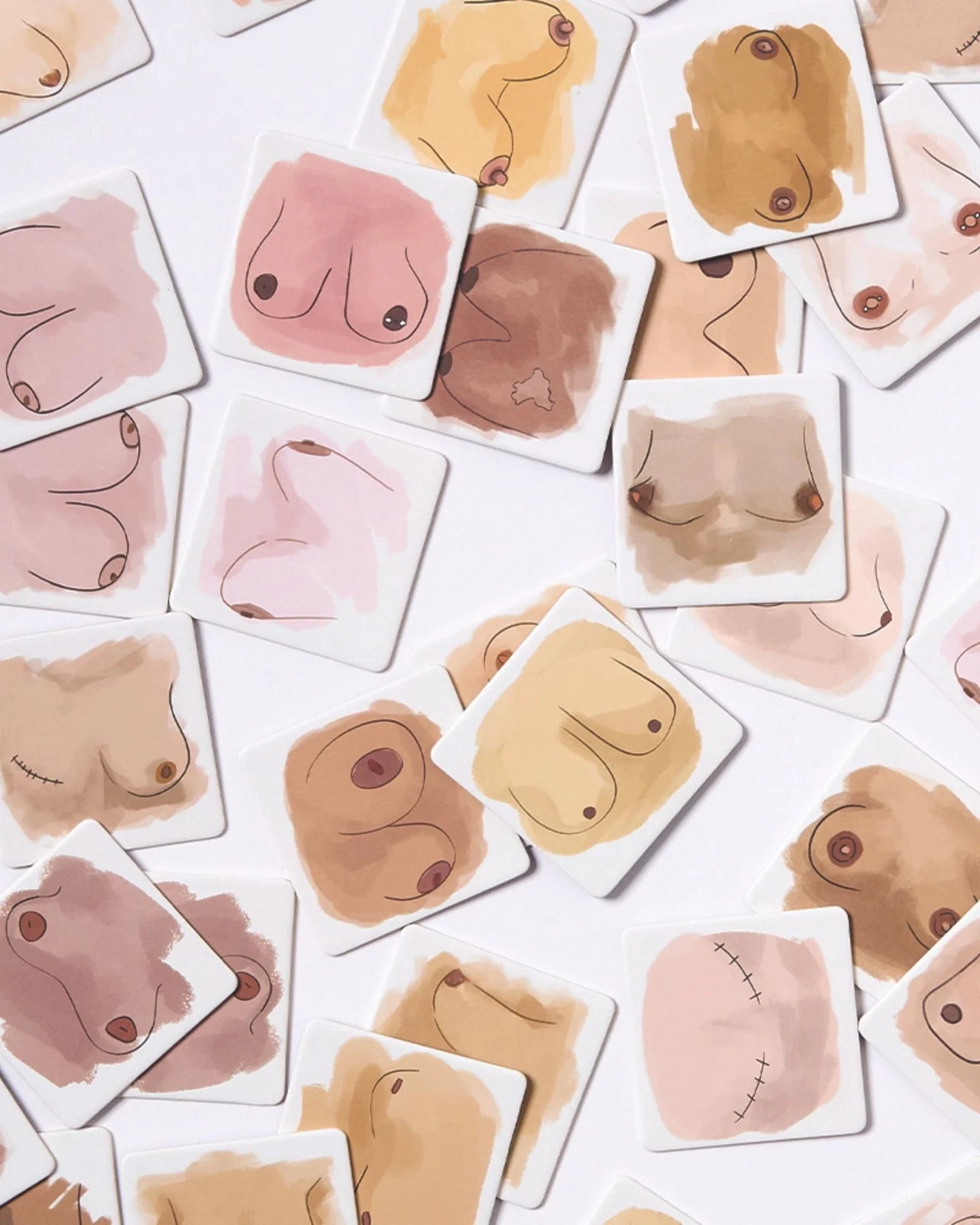 Collection of abstract skin-toned breast shapes on a white background