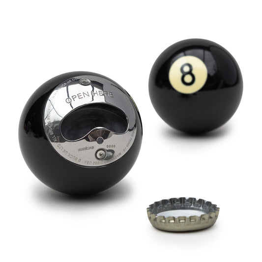 A 8 Ball and a bottle opener with a beer cap in the foreground on a white background.