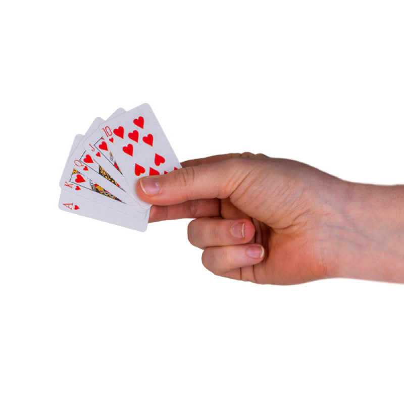 Hand holding a hand of playing cards with a white background